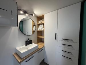 a bathroom with a sink and a mirror at Dushka Mountain Cabin in Belec +56 photos