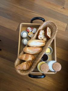 a basket filled with lots of different types of bread at B&B de Trochset in Balk