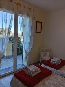 a bedroom with two beds and a balcony at Appartamento Taggiasca con piscina - Riva Trigoso in Sestri Levante +54 photos