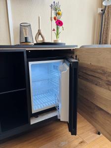 a refrigerator with its door open in a room at B&B de Trochset in Balk