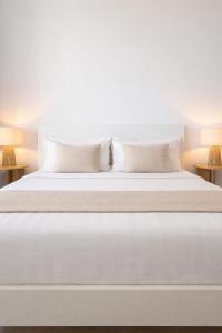 a large white bed with two pillows on it at Nogalera Sea View Luxe in Torremolinos +23 photos