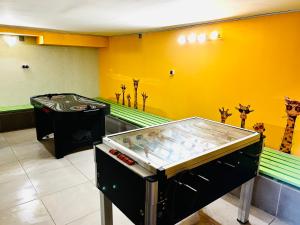 a games room with a pinball machine in the middle at Къща за гости Касида in Sapareva Banya