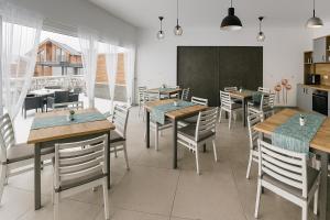 a dining room with tables and chairs in a restaurant at Къща за гости Касида in Sapareva Banya