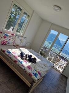 a bedroom with a bed with shoes on it at Ferienwohnung Suter in Seewen