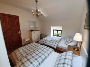 a bedroom with two beds and a door at An Cnocan in Sneem