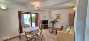 a living room with a table and a couch at Apartmani Dolac in Ivan Dolac