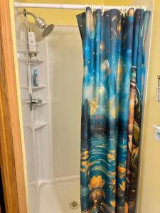 a shower curtain in a bathroom next to a tub at The Wellington Lake Cottage in Middlebury +142 photos