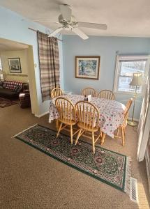 a dining room with a table and chairs at The Wellington Lake Cottage in Middlebury
