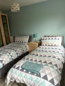 a bedroom with two beds next to each other at Grooms cottage in South Collingham