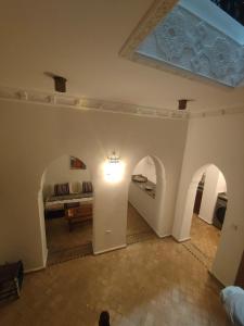 a living room with a bed and a room with arches at Riad Privé Bkl luxury Dar Baroud in Tangier