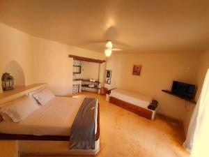 a bedroom with two beds and a flat screen tv at Salto Corumbá Hotel Camping Clube in Corumbá de Goiás