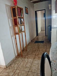a room with a tiled floor and a book shelf at Valdez Resi in Santa Rosa