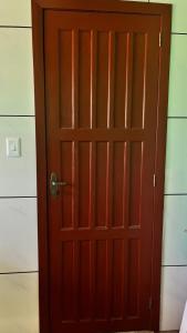 a wooden door in a room with at Pousada Azambuja in Cidreira