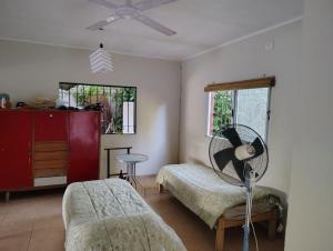 a living room with a fan and a bed at CASA QUINTA Sasha in Sauce Viejo