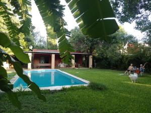 a house with a swimming pool in a yard at CASA QUINTA Sasha in Sauce Viejo