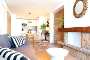 a living room with a couch and a fireplace at Nogalera Sea View Luxe in Torremolinos