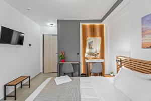 a bedroom with a bed and a desk and a mirror at Athens Vein in Athens