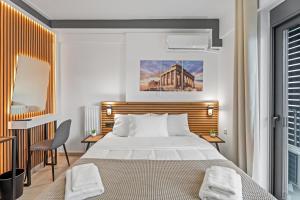 a bedroom with a bed and a desk with a chair at Athens Vein in Athens