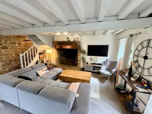 a living room with a couch and a table at Chez Audrey & Bastien in Dinan