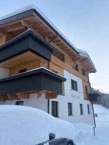 a snow covered car parked in front of a building at Augl‘s Hof in Ischgl