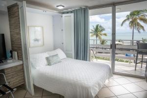 a bedroom with a bed and a view of the ocean at Sea For Yourself in Fajardo