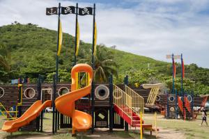 a playground with a slide and slides at Sea For Yourself in Fajardo