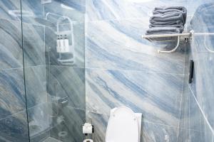 a bathroom with a toilet and a glass wall at Sea For Yourself in Fajardo +31 photos