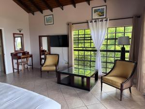 a bedroom with a bed and a table and chairs at forst home with a great ocean view in Kingstown