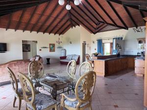a dining room and living room with a table and chairs at forst home with a great ocean view in Kingstown