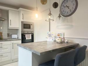 a kitchen with a counter and a clock on the wall at Cierons château in Derry Londonderry