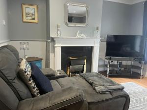 a living room with a couch and a fireplace at Cierons château in Derry Londonderry