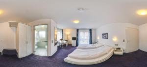 a bedroom with a large bed in a room at Hotel Gasthof Traube in Kernen