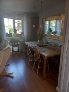 a dining room with a wooden table and chairs at Beautiful detached home in Evesham