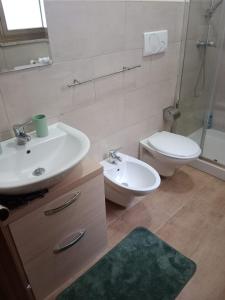 a bathroom with a sink and a toilet and a mirror at Fashion room in Altamura +9 photos