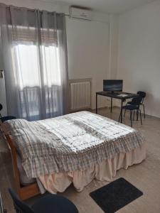 a bedroom with a bed and a table and chairs at Fashion room in Altamura