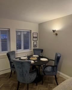 a dining room with a black table and chairs at Entire Flat in Lichfield City Centre in Lichfield