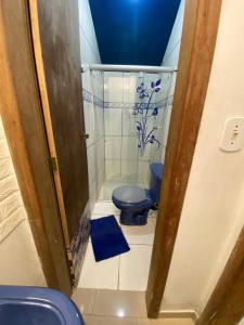 a bathroom with a blue toilet in a stall at Suítes no centro Histórico Diamantina in Diamantina +30 photos
