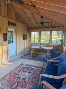a living room with a table and chairs in a cabin at Cattail Cabin in Waterville