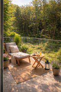 a patio with a chair and a table on a balcony at Homestay in Dąbrowa Górnicza