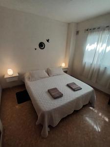 a bedroom with a bed with two towels on it at Casa Serena in Munro +8 photos