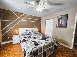 a bedroom with a bed and a ceiling fan at Cozy 3-Bedroom Haven, Private Pool & Parking ! in Longueuil +24 photos