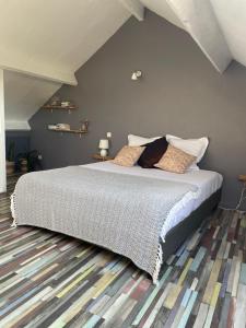 a bedroom with a large bed in a room at Le Fort Vauban in Ambleteuse