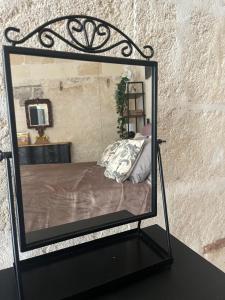 a mirror on a table with a bed in it at ITALY Home 16 in Grottaglie