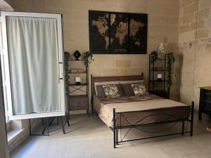 a bedroom with a bed and a large window at ITALY Home 16 in Grottaglie