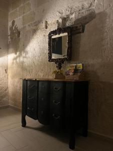 a black dresser with a mirror on a wall at ITALY Home 16 in Grottaglie +54 photos