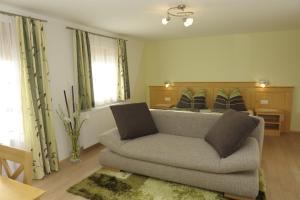 a living room with a couch and a bed at Urlaub am Raderhof in der Ferienregion Lungau in Mauterndorf