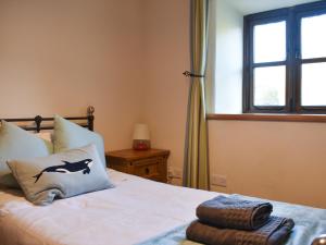 a bedroom with a bed and a window at Oaktree Cottage-Uk42227 in Low Borrowbridge +8 photos