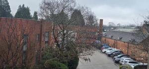 a row of cars parked next to a brick building at Town Centre Studio with Ensuite in Aylesbury