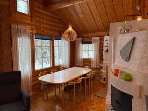 a dining room with a table and some windows at Villa Rukan Honka in Ruka +16 photos