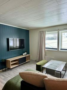 a living room with a tv and a couch and a table at 2 beds apartment centrally located in Gravdal in Gravdal